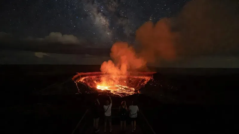 Glowing lava at night in Hawaii Volcanoes National Park viewed from a Big Island stargazing tour departing from Kona Hawaii